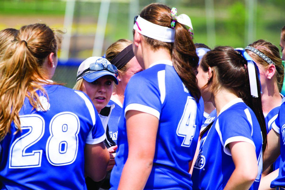 The team gathers for a pep talk on the field on Sunday. JOEL VENZKE | PHOTO EDITOR