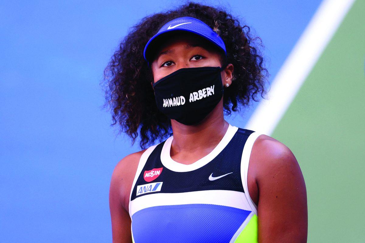 NEW YORK, NEW YORK - SEPTEMBER 04: Naomi Osaka of Japan wears a protective face mask with the name, Ahmaud Arbery stenciled on it after winning her Women's Singles third round match against Marta Kostyuk of the Ukraine on Day Five of the 2020 US Open at USTA Billie Jean King National Tennis Center on September 04, 2020 in the Queens borough of New York City. Ahmaud Arbery, was an unarmed 25-year-old African-American man, was pursued and fatally shot while jogging in Glynn County, Georgia. (Photo by Al Bello/Getty Images)