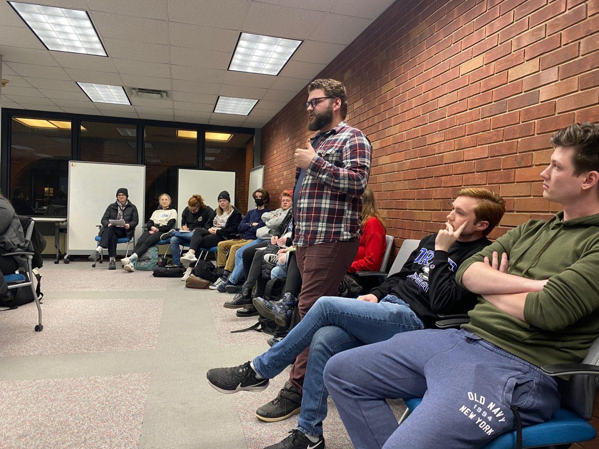 DUiN Editor-in-Chief Carl Yaeger speaks in favor of the fee increase at the Feb. 23 Student Senate Meeting, citing concerns about wage theft and violations of federal labor law. 