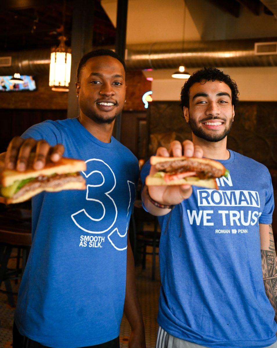 Wilkins and Penn with their burgers