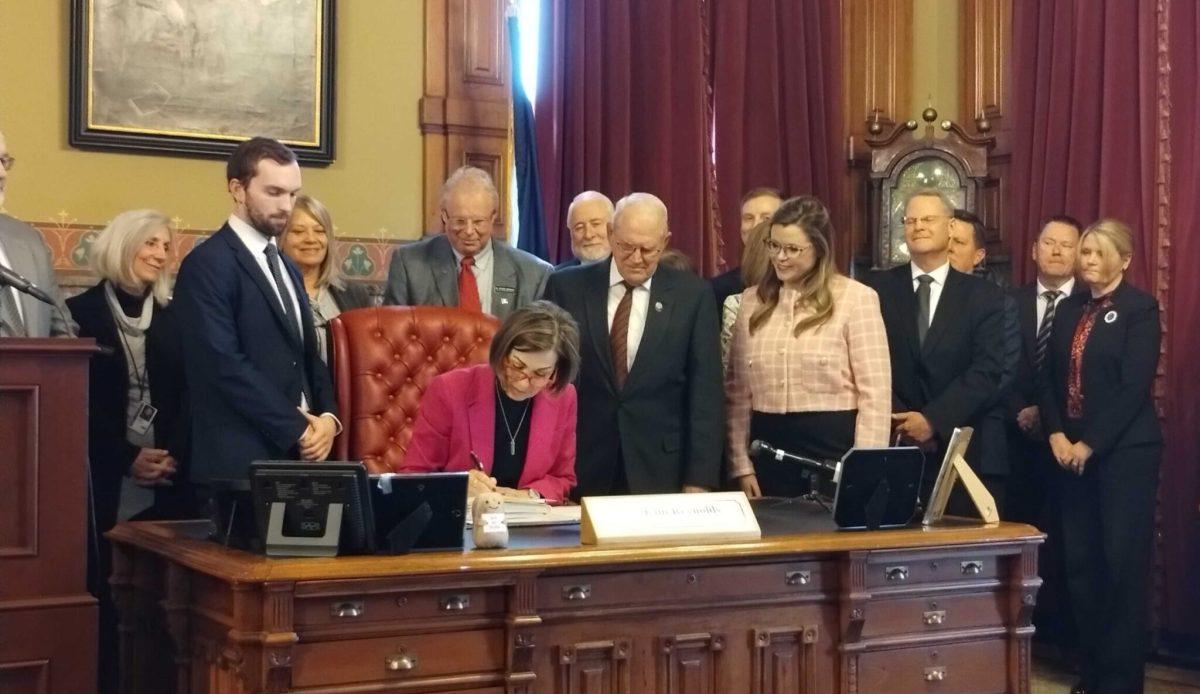 Gov. Kim Reynolds signed House File 2612 — also known as the AEA bill — into law on March 27. The bill redirects 10% of special education funding from Area Education Agencies to school districts and increases teacher salaries. Democrats argued that the bill is out of touch with Iowans. Photo by Robin Opsahl | Iowa Capital Dispatch