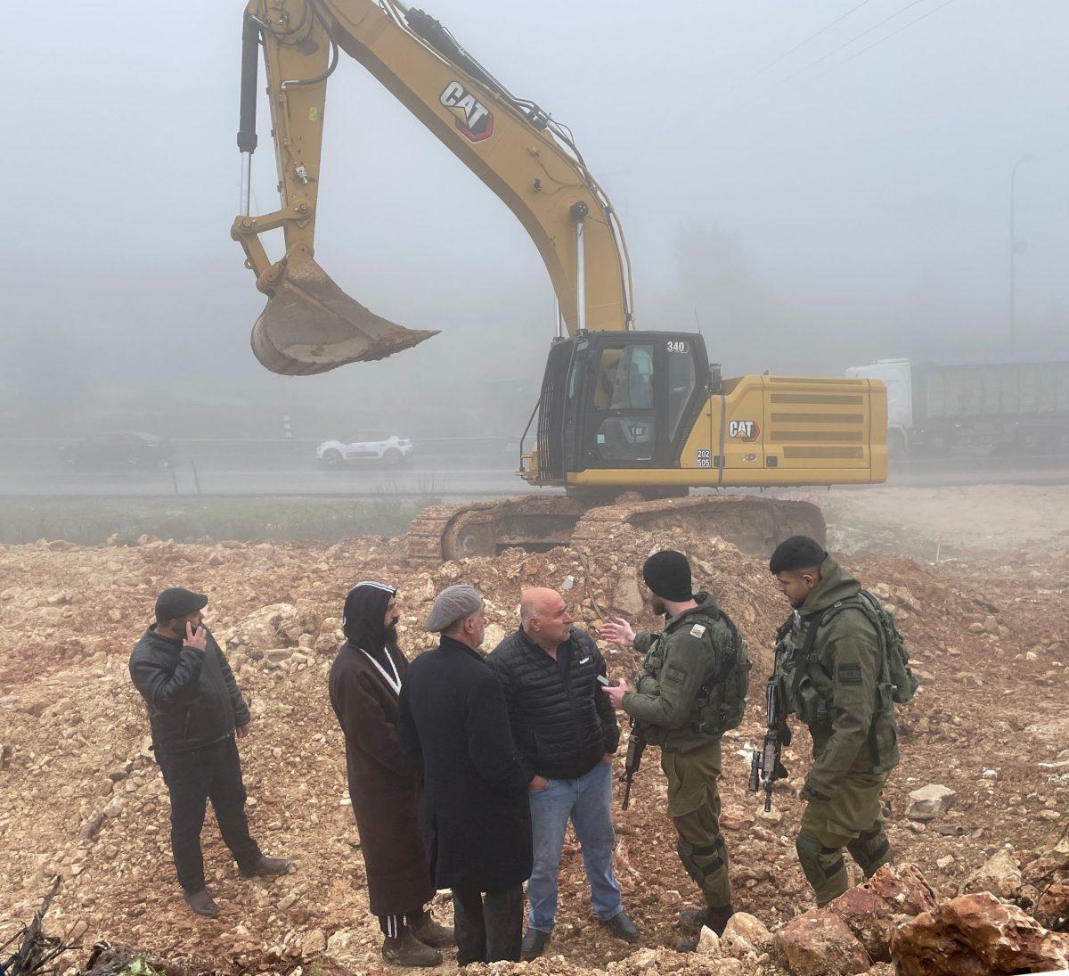 Palestinians try to negotiate with Israeli soldiers to stop the demolition and confiscation of their property in Husan, a town south of Bethlehem. Photo Courtesy of Amgad Beblawi.