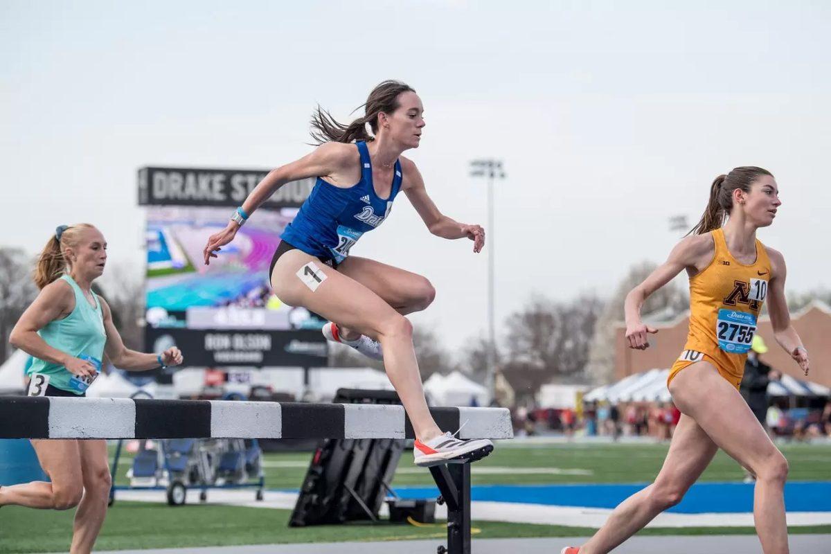 Brooke Mullins jumps over a hurdle during the Drake Relays