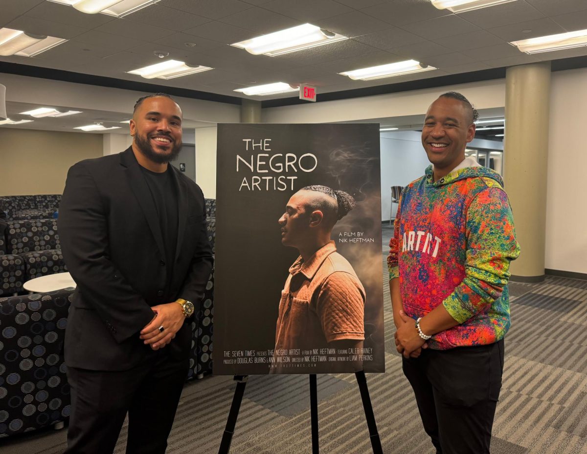 Caleb Rainey and Nik Heftman pose with the poster for their documentary. The film detailed Rainey’s creative process, among other things