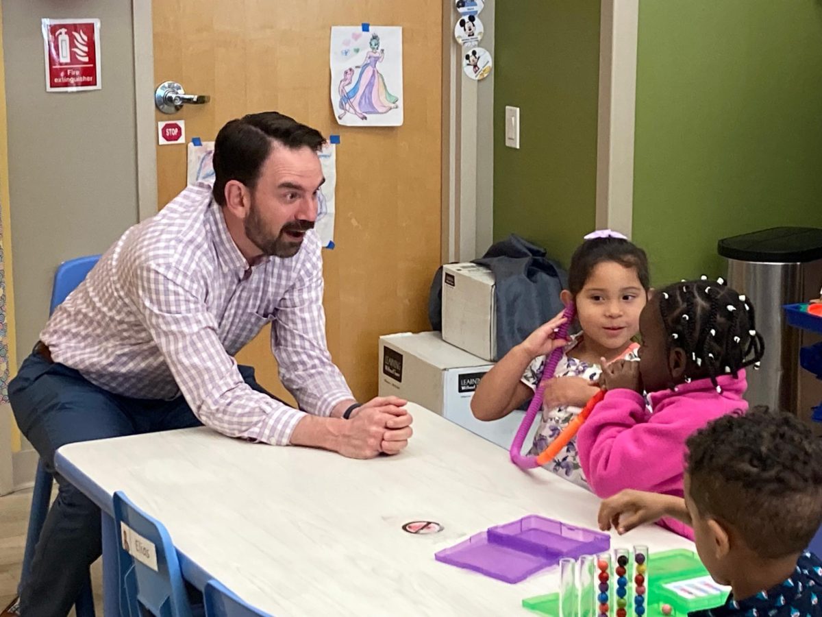 Ryan Wise, dean of the School of Education, visits with children enrolled in the Head Start program. The program has several branches across the state. photo courtesy of Ryan Wise