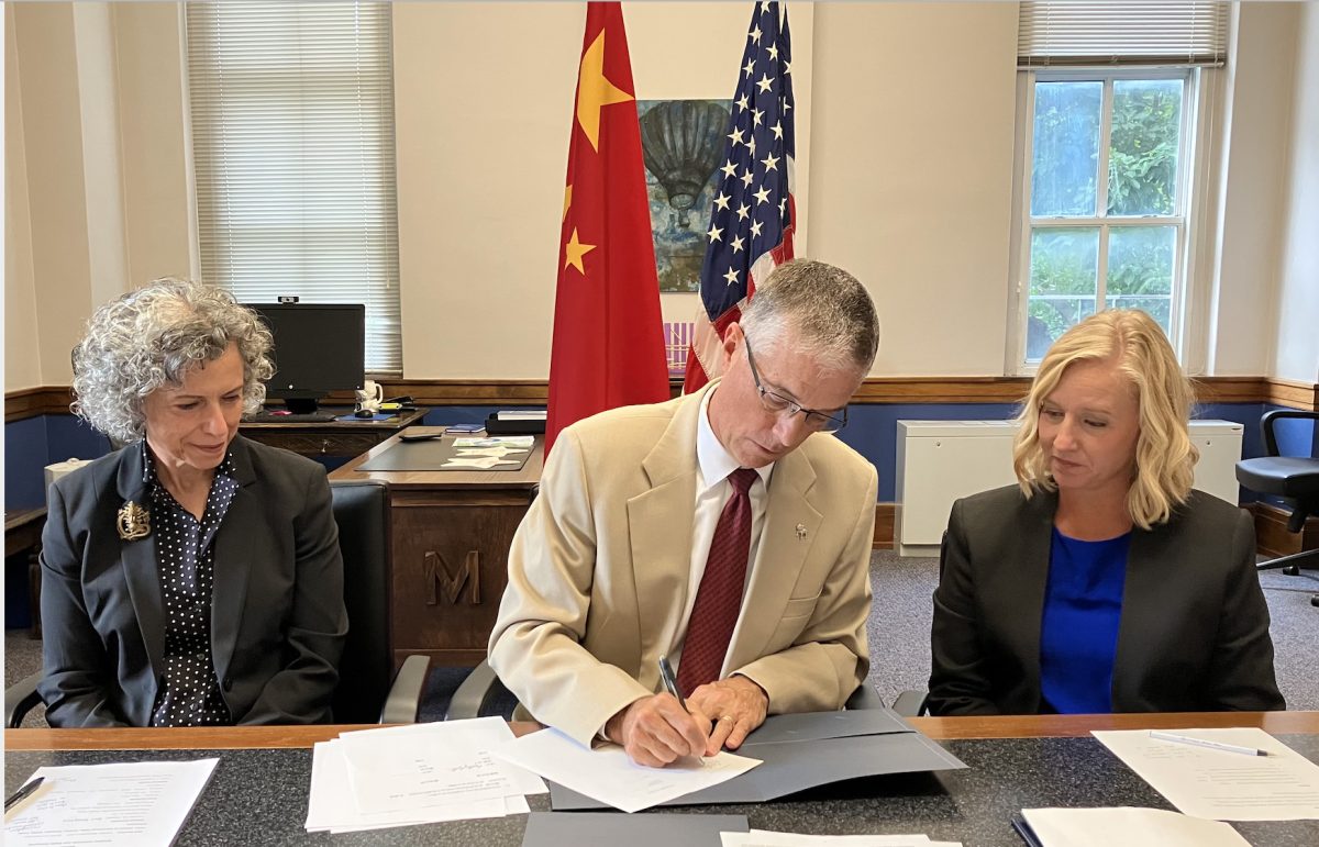 Drake President Marty Martin presents the Qingdao-Drake United College partnership. Photo courtesy of Sue Mattison.