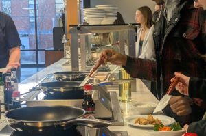 Students make meals at the UCook station on the north side of the dining hall. 