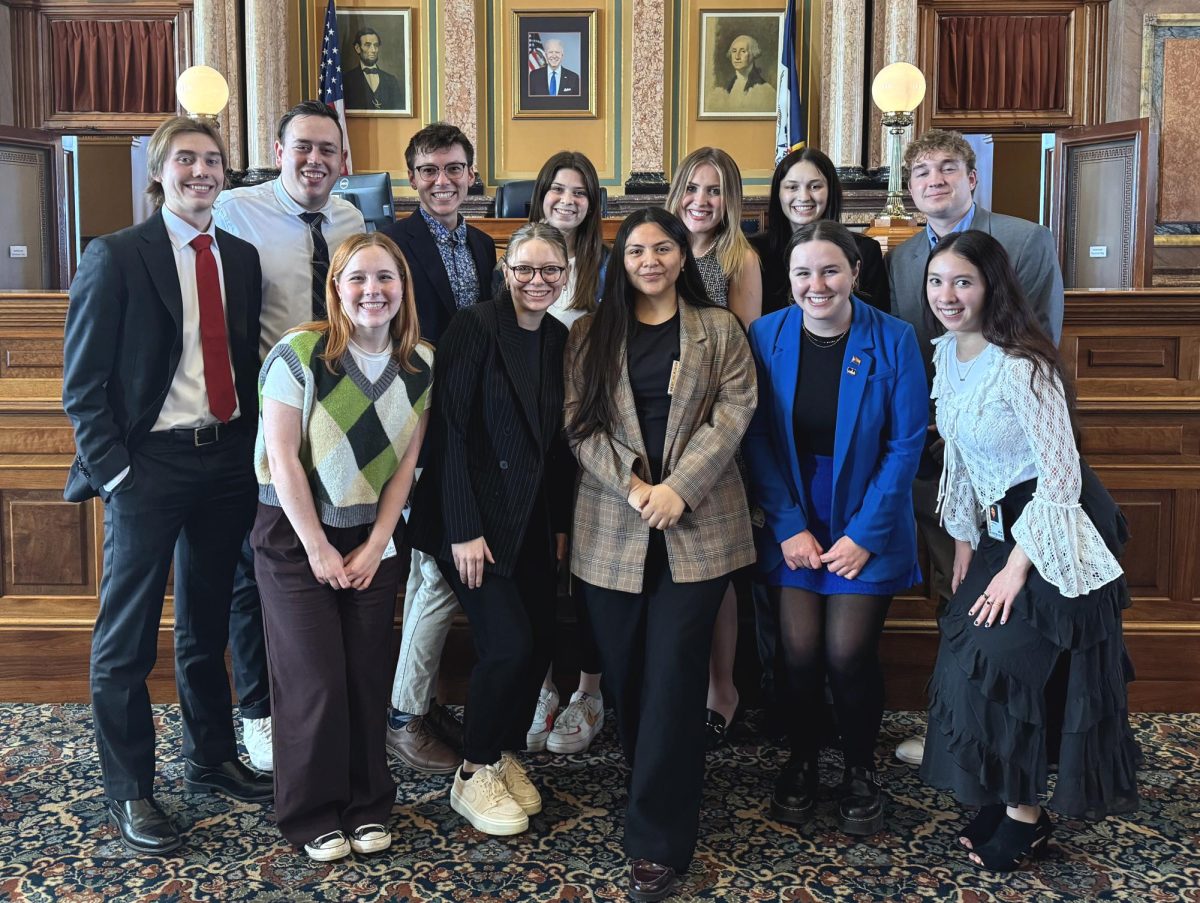 Drake student clerks pose on the House floor at the end of the 90th session. The University’s proximity to the Capitol provides students who are interested in politics with easy access to local and state political work. Photo courtesy of Gavin Hoedl.