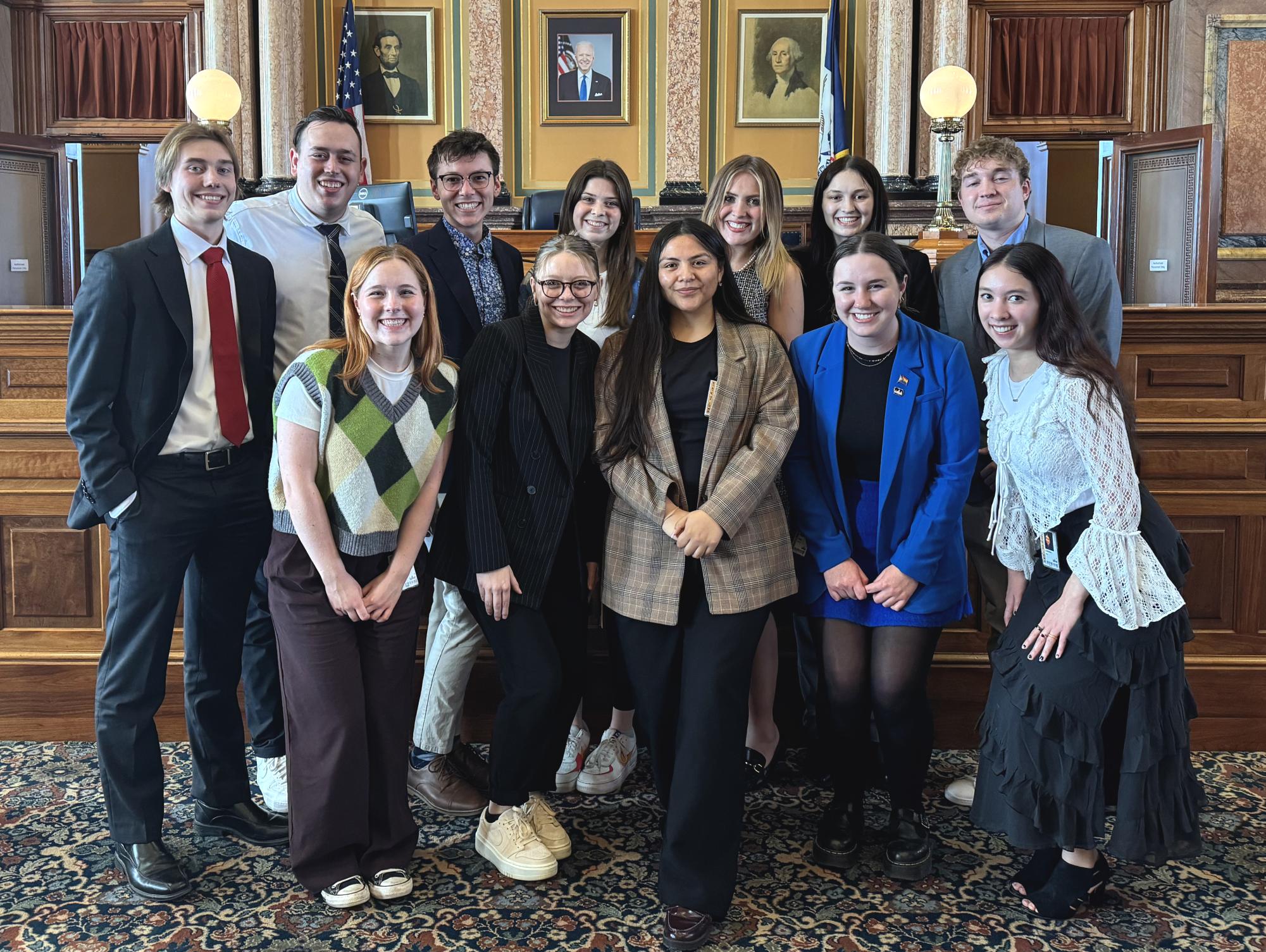 Drake student clerks pose on the House floor at the end of the 90th session. The University’s proximity to the Capitol provides students who are interested in politics with easy access to local and state political work. Photo courtesy of Gavin Hoedl.