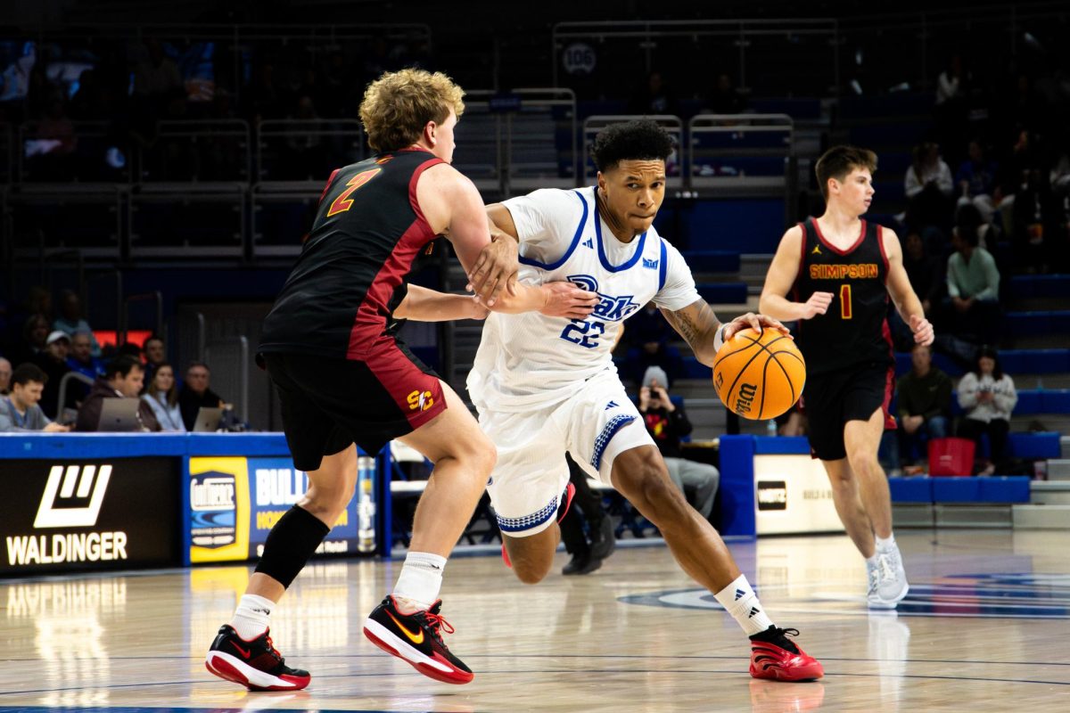Jaehshon Thomas takes the ball down the court during a Nov. 10 game against Simpson College in the Knapp.