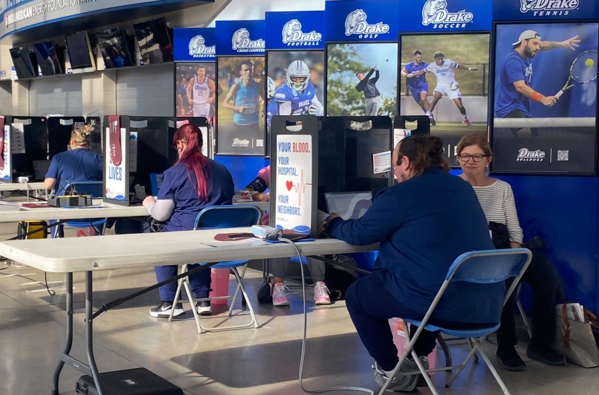 A LifeServe Blood Center worker meets with a blood donor on Feb. 11 in the Knapp Center for Drake’s first Bulldog Basketball Blood Drive. Volunteers received free Drake basketball tickets and a T-shirt after donating. 