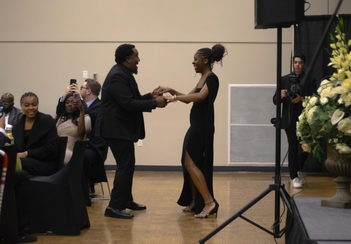 CBS President Natasia Johnson dances with her uncle while the Diamond Empire Band performs. 