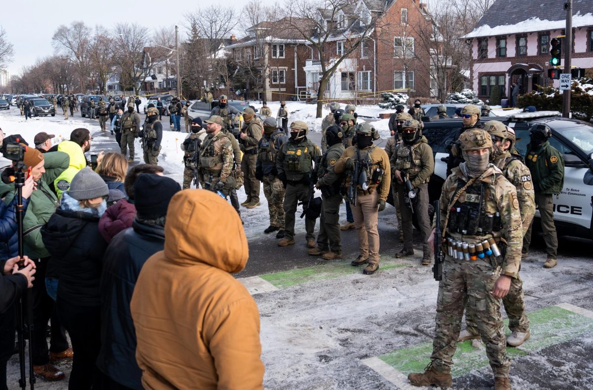 ICE agents line a street in South Minneapolis after an agent fatally shot Renée Good on Jan. 7. Photo courtesy of Chad Davis via Flickr