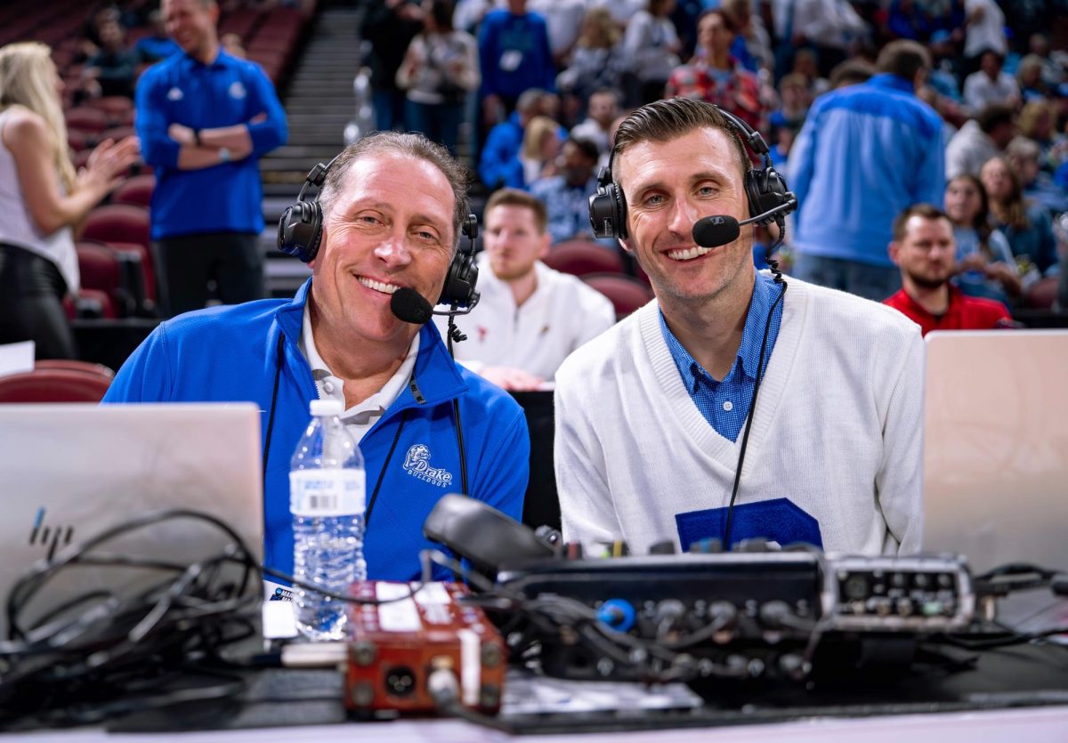 Director of Broadcasting Michael Admire (right) came to do play-by-play for Drake University after covering the death of the previous broadcaster in a 2018 flood. Since then, he has aimed to immerse himself in the Drake community. “I identify so much with Drake,” Admire said. “Even though we may be undersized, underfunded, all those things, we’re going to swing way above our weight class, and it’s because of the people behind the scenes working their tails off.” Photo courtesy of Drake Athletics 