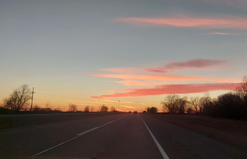 On the way to Saylorville Lake, this writer took a picture of the sun setting on the road. This writer argues that moments like these are what college students should savor while here. Photo courtesy of Jacob Byers