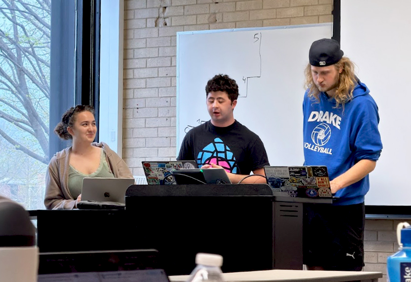 Students Arran Davis, Sean Groh and Jonah Rosenquist present their findings to another class. Presenting research is a key goal of Research Seminar in Immigration Policy. Photo courtesy of Adrien Halliez
