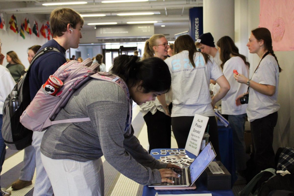 A Drake University student donates to the school, part of the yearly All In 24-hour giving campaign. This year, the campaign is themed “Opened Doors.” Photo courtesy of Kim Jones 