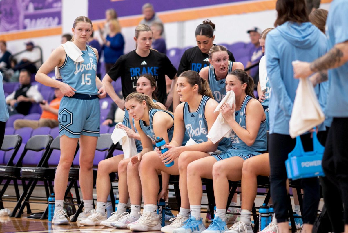 Women’s basketball players take a breather on the sidelines during a Feb. 28 game at the University of Evansville. Photo courtesy of Drake Athletics